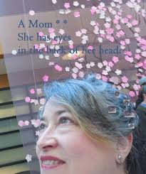 What is the correct phrase to use when describing someone inheriting their  mother's blue eyes, "takes in" or "takes after"?