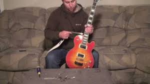 Pull the string end of the strap out from under the guitar, and bring it up to hook on the edge of the soundhole. How To Install Guitar Strap Locks Play Guitar