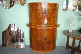 The piece is topped with a black marble top and sits atop a black pedestal. Original Art Deco Walnut Cocktail Bar Cloud 9 Art Deco Furniture Sales