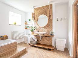 A serene nordic bathroom with an oval tub, storage niches, a long vanity with a sink and potted greenery. 10 Scandinavian Style Bathrooms To Inspire Your Remodel
