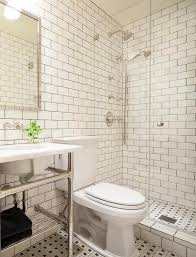 Stunning Black And White Bathroom Features Walls Lined With White Subway Tiles Accented With Black Gr Tile Bathroom Subway Tiles Bathroom Bathroom Tile Designs