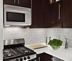White Corian Countertops Daltile Gray Subway Tile Backsplash And Walnut Cabinets Tiny Kitchen Kitchen Makeover Kitchen