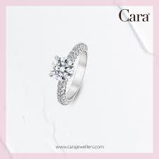 The 1 35 Carat Round Brilliant Diamond Accented By 1 13 Ctw Smaller Diamonds On A Platinum Ban White Gold Engagement Rings White Gold Earrings Damas Jewellery