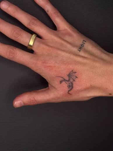 Tiny fineline dragon tattoo, delicate, detailed, and designed to sit subtly on the skin while still carrying real character. Dragons are one of those timeless motifs that work beautifully in a minimal