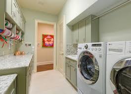 Laundry room and office combo features white cabinets adorned with nickel hardware paired with marble countertops and a white mini subway tiled backsplash. Laundry Craft Room Remodel Beach Style Laundry Room Miami By Cutting Edge Construction Woodworks Inc Houzz