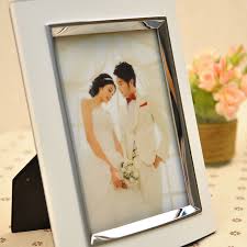 For a more traditional and elegant look, this glass picture frame can be engraved with you and your spouse's names and wedding date. 7inch Fashion Wedding Style Home Decoration Photo Frame Metal Home Decor Frames