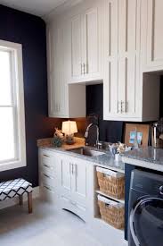 Laundry room cabinets are usually made out of some sort of wood. Navy Blue Adds A Deep Sea Look To A Classic White Laundry Room Dura Supreme Cabinetry