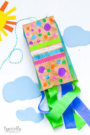 Cute colorful tissue paper stained glass kites decorating our windows. Paper Bag Kite Craft Typically Simple
