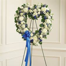 A stratified limestone background gives a casket a place of honor. Blue White Standing Open Heart Katy Tx