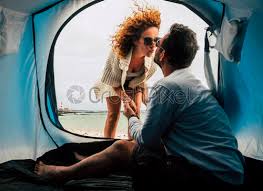 The tent blocks drafty wind in the room while. Camping Tent Vacation And Adult Couple Man And Woman Enjoying Stock Photo Crushpixel