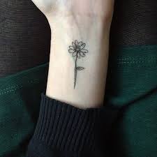 This Would Be Perfect On Outer Upper Left Arm Small And Feminine Maybe Longer More Whimsical Stem Daisy Tattoo Designs Flower Wrist Tattoos Small Daisy Tattoo