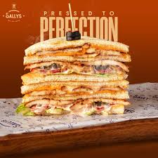 Spice up your mealtime with our Mocktail Sandwich! The combination of juicy  grilled chicken, crispy jalapeños, savory olives, melted cheese, and our  signature sauce will leave you craving for more. #SallysBurgers  #MocktailSandwich #