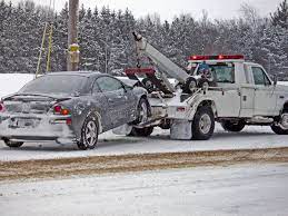 Wrecker Towing A Car In Winter Damaged Vehicle Being Towed Away By A Wrecker Ad Car Winter Wrecker Towing Tow Truck Towing Service Tow Truck Driver