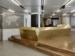 Clean lines, neutral colors and a touch of shimmery elements. Gold Concierge Desk Inspiration Possibly Curved Rather Than Geometric Hotel Reception Desk Reception Counter Design Reception Desk