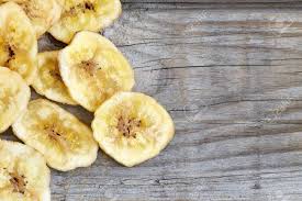 Maybe you would like to learn more about one of these? Homemade Banana Chips Dried And Fried Banana Slices On Wooden Background Top View With Copy Space Stock Photo Picture And Royalty Free Image Image 83290134