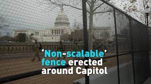 A us capitol police officer stands outside a security fence as it is erected around the us capitol in the fencing will be up for the next 30 days. Non Scalable Fence Erected Around The Perimeter Of U S Capitol Cgtn