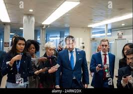 In this Wednesday, Jan. 29, 2020 photo, Al Rehder, left, talks with Larry  Koland in Rehder's car condo at the Eagan Car Club in Eagan, Minn. Behind  Rehder's 1939 Ford is a