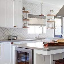 We love how it fits into this modern kitchen! White Herringbone Kitchen Backsplash Tiles With Gray Grout Classic White Kitchen Grey Kitchen Tiles White Kitchen Tiles