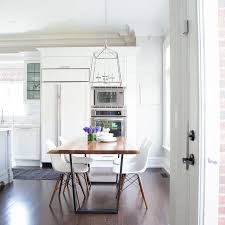 White, wood, farmhouse kitchen & dining room chairs : Iron And Wood Dining Table With White Molded Plastic Dining Chairs Transitional Dining Room