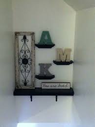 The size of the sofa positioning two large framed photos above the couch zeroes in the focus. Stair Decor Stairway Decorating Decorating Stairway Walls