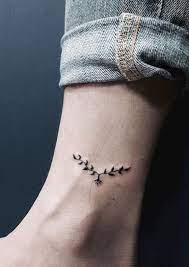 Mudra holding a tobacco plant tattoo. Small Plants Tattoo Design On Leg Small Meaningful Tattoos Meaningful Tattoos Crayon