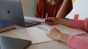 Creative person developing a product idea in a notebook