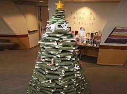 Place a dab of glue on the center of the top of your completed paperback book tree. Cool And Kitschy Christmas Tree Made Of Library Books