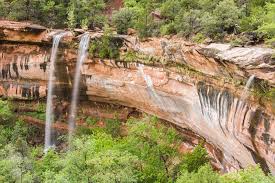 A stream of water descends from the canyon rim down to the virgin river, passing through three tiers of pools. Waterfalls In Zion National Park
