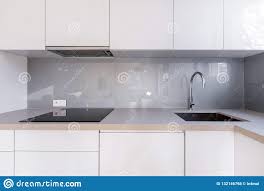 white kitchen with gray backsplash