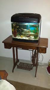 Old Singer Sewing Machine Serving As A Fish Tank Stand