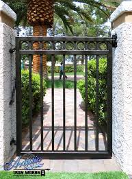 Learn how to build garden gates and fences with bunnings. Wrought Iron Side Gate With Circles And Spear Finials The Transparency Is Ideal For The Surveillance Camera Iron Garden Gates Garden Gates Iron Gate Design