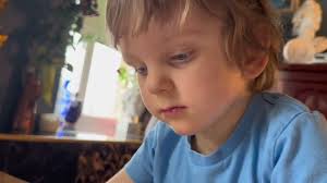 Gavriil is reading music sheets of Mozart an Grieg