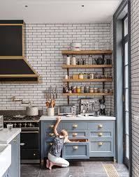 Tasha at kaleidoscope living updated her kitchen with grey paint on the cabinetry as well as new hardware and industrial modern cage style lighting. Blue Gray Kitchen Cabinets Subway Tiles Brass Detailing And Vintage Black And Brass Appliances Wow Kitchen Design Luxe Kitchen Kitchen Interior