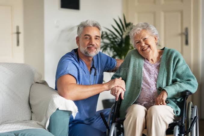 Elderly companion caregiver checking up on senior client