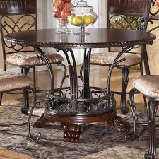Ashley Furniture Alyssa Round Single Pedestal Dining Table With Metal And Wood Base Miskelly Round Dining Room Table Round Dining Room Sets Round Dining Room