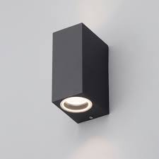 The shape of an uplight wall sconce forms and focuses light in a very specific direction, allowing light to pour out and up in a fascinating display. Axel Cube Outdoor Up Down Wall Light Lampsy