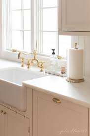 New Kitchen A Cream Kitchen With Timeless Design And Gold Faucet In 2020 Kitchen Sink Organization New Kitchen Inspiration Classic Kitchen Design