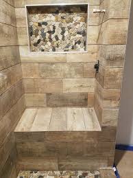 Wood Tile Shower Seat With River Rock Niche Finished Basement Bath Wood Tile Shower Shower Tile Pebble Shower Floor