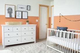Large nursery room with white walls, curtains and rug along with the hardwood flooring. 12 Colorful Gender Neutral Nursery Palettes