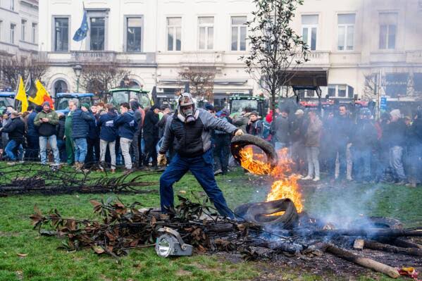 European farmers clash with police at EU summit in Brussels | AP News