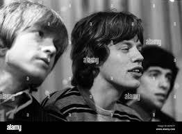 Mick Jagger talks as the Rolling Stones attending a press conference after  arriving in the USA June 1964 Stock Photo