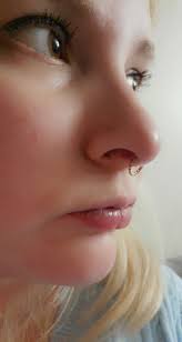 Why do I feel electric shock from beer can to nose ring?