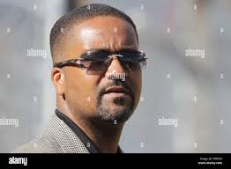 Oklahoma State head coach Frank Anderson has a meeting with at the mound  after they loaded the bases in the eighth inning against Louisville during  the first game of the NCAA Baseball
