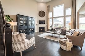 The Two Story Family Room Makes This New Home Feel Spacious And Open Which Do You Like More The Window Wall Creating A Bright Air Home Great Rooms New Homes