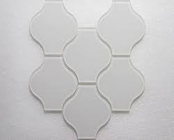 The tiles stay in line with the kitchen's neutral color palette and create a calming space. Lanterna Waterjet White Clear Glass Mosaic Tile Wj 936