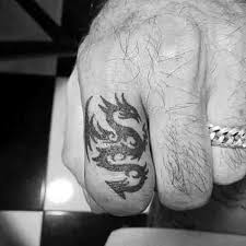 This simple dragon tattoo beautifully combines tribal strokes and design elements and manages to depict a dragon head and a tail. 60 Simple Dragon Tattoos For Men Fire Breathing Ink Ideas