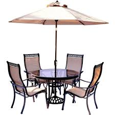 Patio dining sets feature rectangular, round, square or oval tables, and many include a space for a patio umbrella so the bright midday sun. Hanover Monaco 5 Piece Outdoor Dining Set With Round Glass Top Table And Contoured Sling Stationary Chairs Umbrella And Base Mondn5pcg Su The Home Depot Patio Furniture Sets Glass Top Dining Table Outdoor Dining