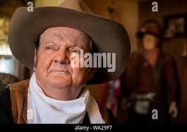 Lodi, CA, USA. 16th Aug, 2019. Jeff Wayne Sutherland, who makes his living  as a John Wayne impersonator, in his living room with his John Wayne  memorabilia