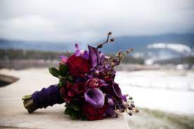 For fall brides, we love the lush look of this red peony and rose arrangement accented with blue thistle, amaranthus, and seeded eucalyptus. 100 Ideas For Winter Weddings Purple Wedding Flowers Purple Bridal Bouquet Purple Wedding Bouquets