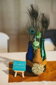 Wedding Centerpiece Wrapped Bottles Hops Feathers Twine Burlap Rustic Peacoc Peacock Wedding Centerpieces Wedding Decorations Centerpieces Wedding Centerpieces